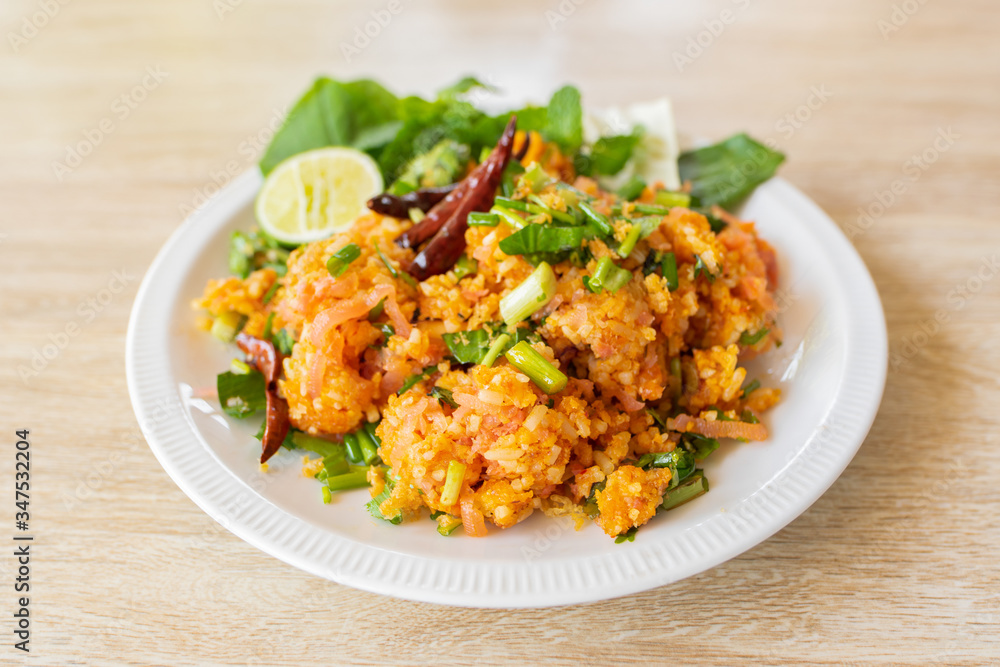 Fermented Pork and Crisp Rice Salad or Yam Naem Khao Tod Recipe,Thai food concept.Top view and wooden background. Fermented Pork and Crisp Rice Salad or Yam Naem Khao Tod Recipe,Thai food concept.Top view and wooden background.