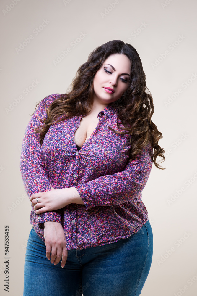 Sexy plus size model in casual clothes, fat woman on beige background ...