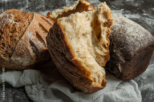 ssortment of fresh organic bread . Assorted bread with flour. photo