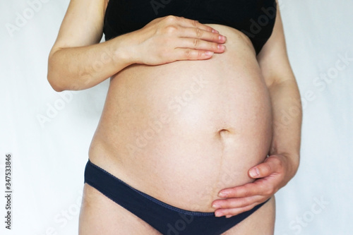pregnant belly of a woman at 9 months of pregnancy