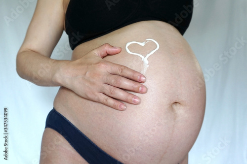 Wallpaper Mural pregnant woman belly skin care Torontodigital.ca