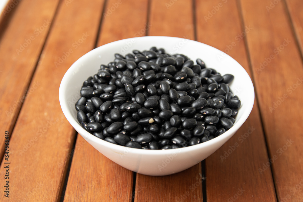 Pile of raw Brazilian Black Beans in a bowl. Also know as 'Feijao' Pile of raw Brazilian Black Beans in a bowl. Also know as 'Feijao'