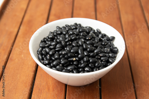 Pile of raw Brazilian Black Beans in a bowl. Also know as 'Feijao'