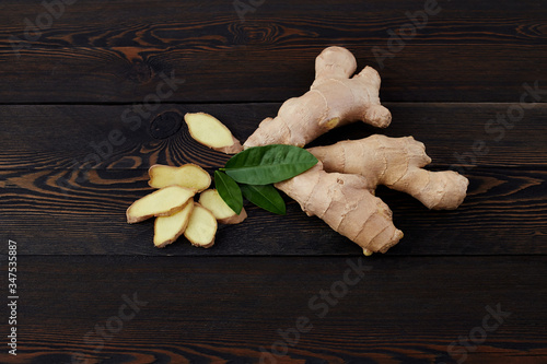 Ginger root on a wooden background, top view photo