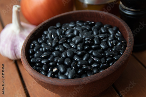 Pile of raw Brazilian Black Beans in a bowl. Also know as  Feijao 