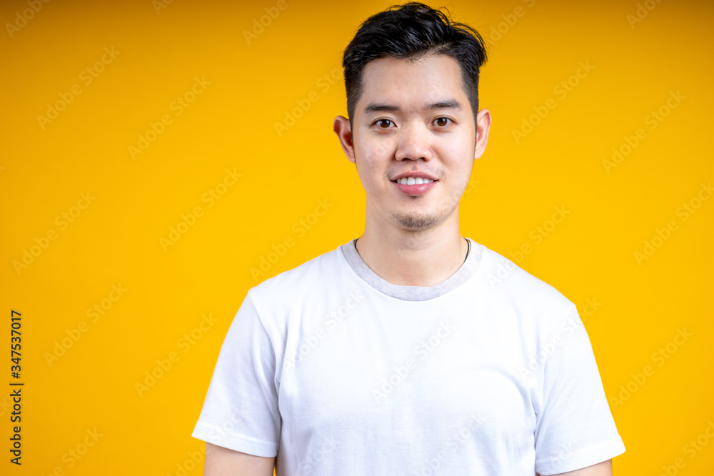 Young Asian man wearing posting isolate on yellow background. Happiness, model. Young Asian man wearing posting isolate on yellow background. Happiness, model.