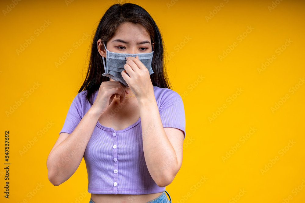 An Asian woman is wearing a health mask and promises not to approach her to prevent an outbreak of coronavirus or covid-19. An Asian woman is wearing a health mask and promises not to approach her to prevent an outbreak of coronavirus or covid-19.