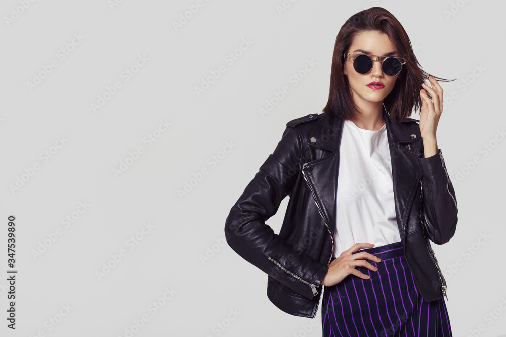 Young beautiful woman in a black jacket - obrazy, fototapety, plakaty 