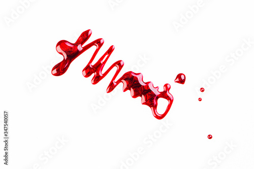 Spilled red nail polish on a white background