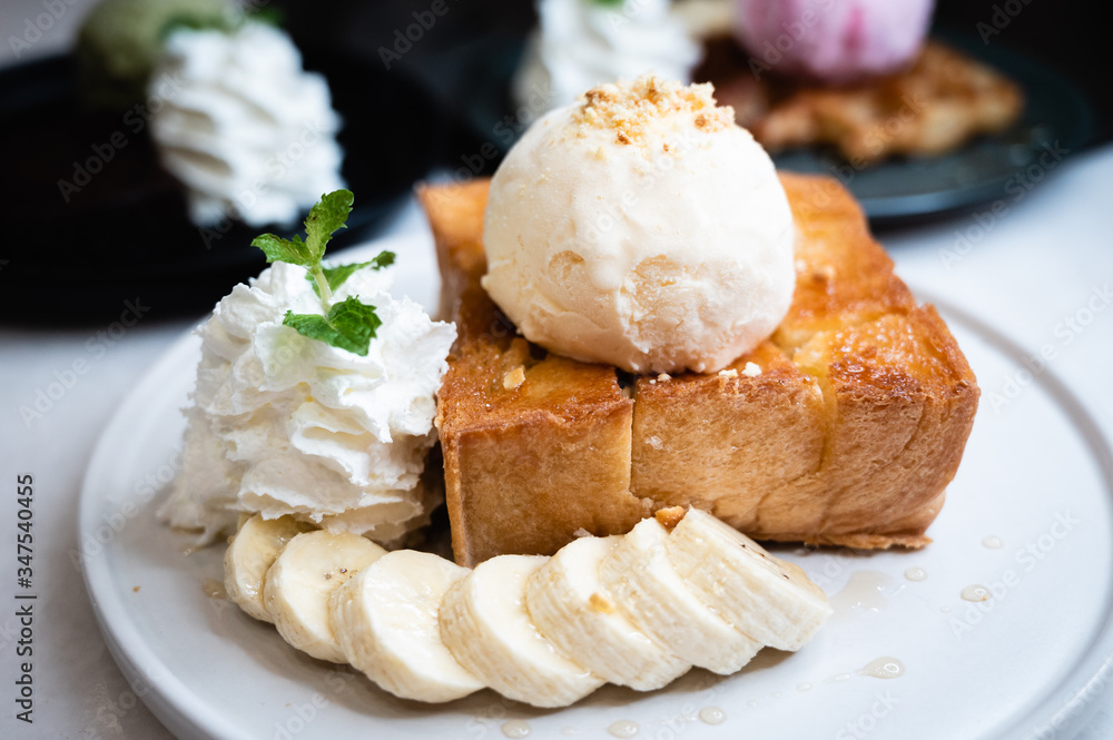 Honey toast with vanilla ice cream, banana and whipping cream