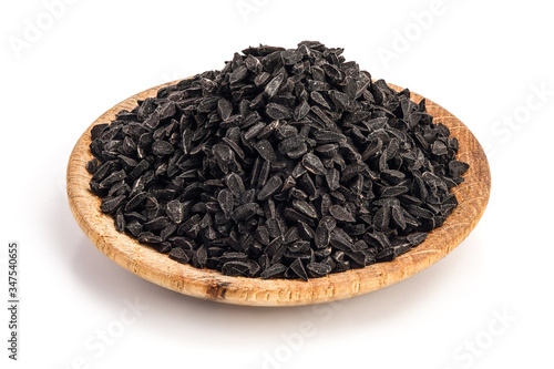 Nigella sativa or Black cumin in wooden plate isolated on white background