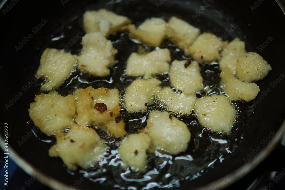 Onion vada with hot oil boiling in cooking pan closeup view, Indian dish making in a traditional home method , some area this is called ulli vada. Onion vada with hot oil boiling in cooking pan closeup view, Indian dish making in a traditional home method , some area this is called ulli vada.