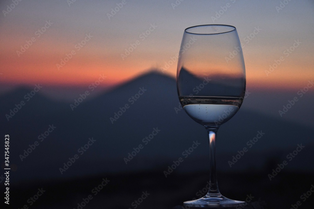 the Euganean hills at sunset time in winter with a glass