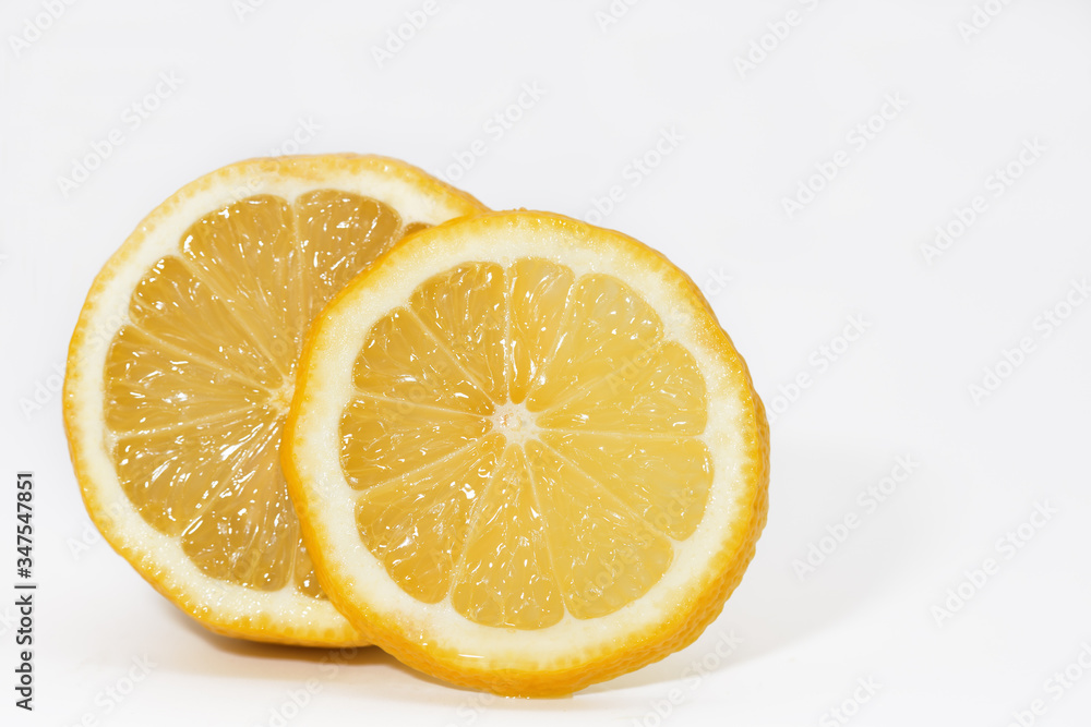 Yellow lemon. Lemon with a sliced slice. White background. Yellow lemon. Lemon with a sliced slice. White background.
