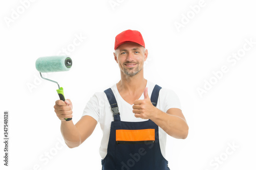 Refresh walls by yourself easily. Decorator hold paint roller. Wall painter. Paint work. Paint shop. Renovation and repair. Renewal and redecorating. Professional equipment. Mature man in cap