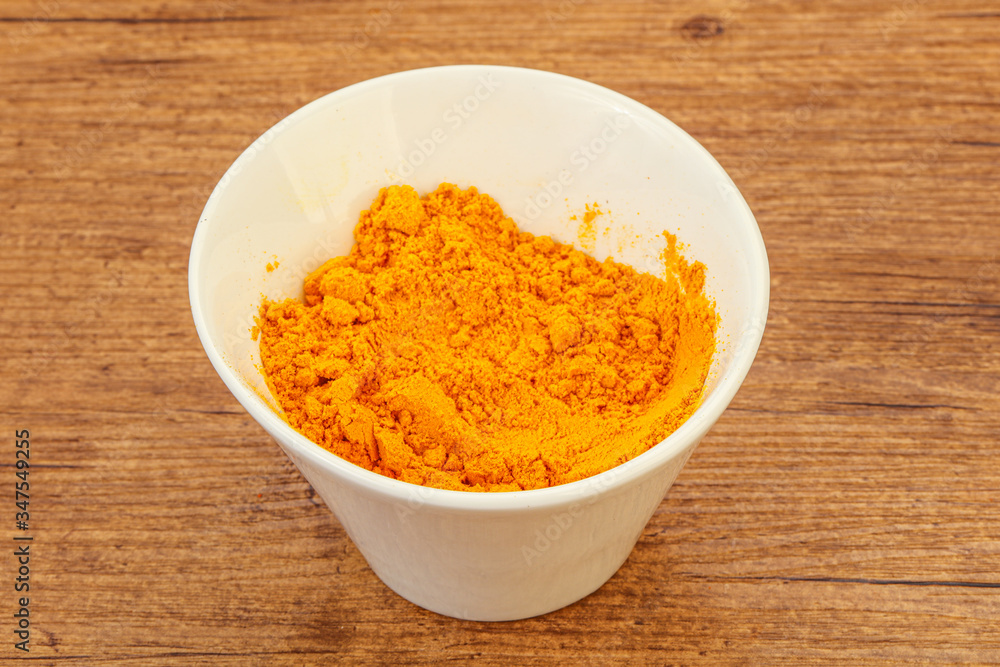 Tumeric powder in the bowl Tumeric powder in the bowl