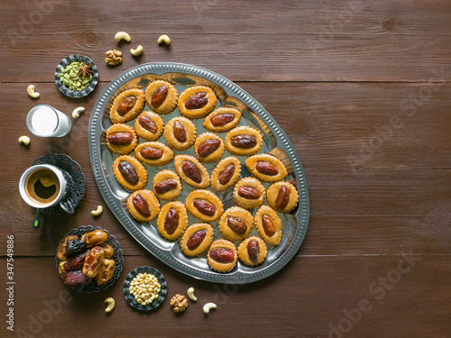 Festive sweet Ramadan background with homemade date cookies on a brown wooden table photo