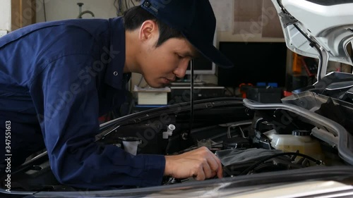 male mechanic checking and repair the engine, car service