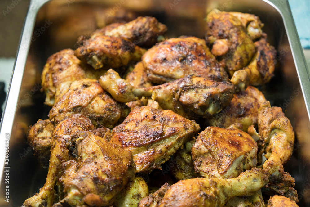 chicken roasted with arabian recipe in the tray and the background of the image blurred.