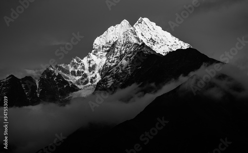 Black and white image of Thamserku mountain peak in Everest Region of Nepal. Black and white mountain peak fine art image. photo