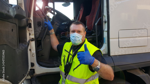 young transporter on the truck with face mask and protective gloves for Coronavirus