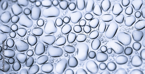 Image from microscopy of water drops in the microscopic slide.Abstract oxygen bubbles in the water.Mixed and different shape background in the black and white tone.