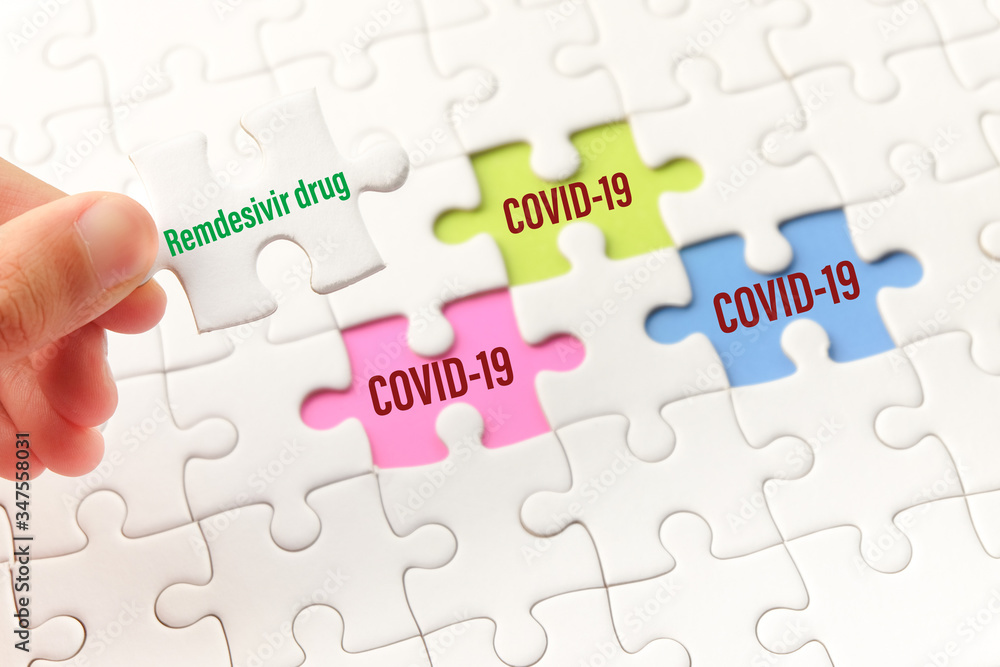 The drug remdesivir word on white jigsaw puzzle go to replace COVID-19 word on blue, green and purple gap - idea answer concept. The drug remdesivir word on white jigsaw puzzle go to replace COVID-19 word on blue, green and purple gap - idea answer concept.
