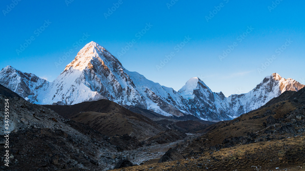 Panoramic image of summits of Pumo Ri and Lingtren mountain peaks in Mahalangur Himalayan range in Sagarmatha National Park in Nepal. This is a UNESCO world heritage site. 