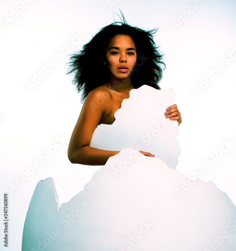 black skined woman in big crashed egg. modern easter hipster concept photo