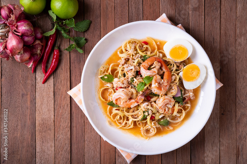 Spicy Thai Banana Blossom Salad with shrimp and boiled egg (Yum Hua Plee).Top view photo