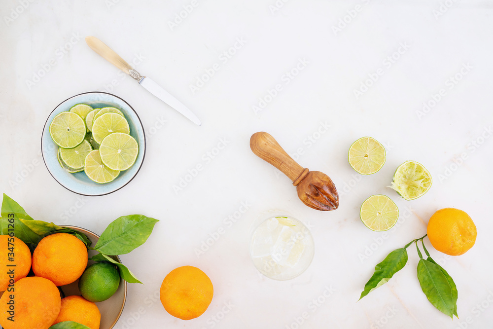 Citrus infused water preparation. Fresh oranges and limes Citrus infused water preparation. Fresh oranges and limes