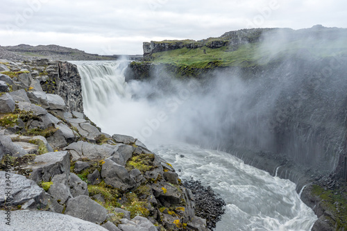 Northern europe most powerful waterfall  the dettifoss in Iceland during early morning hours. Soft light and cloudy sky with big mist swirls. Travelling  holiday and icelandic concept