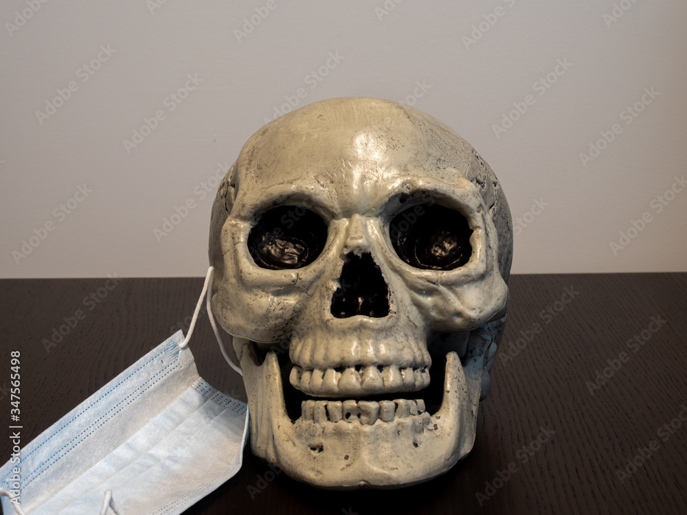 Skull with hospital mask removed on one side Skull with hospital mask removed on one side