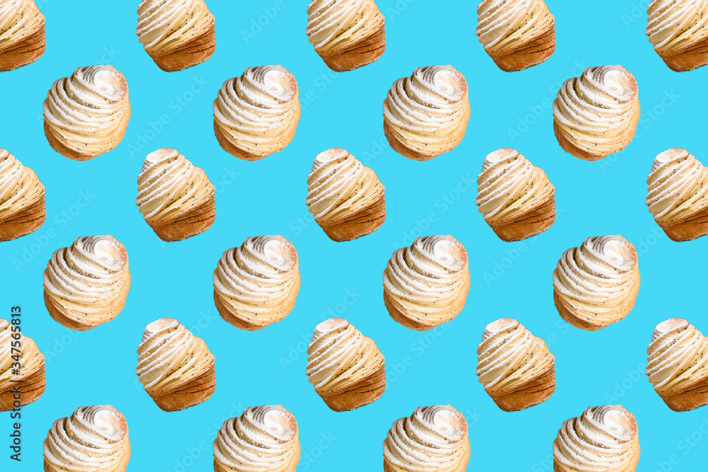 Seamless pattern of baking Cruffins on a blue background. muffins puff croissants trend 2020 . Wallpaper background pattern Seamless pattern of baking Cruffins on a blue background. muffins puff croissants trend 2020 . Wallpaper background pattern