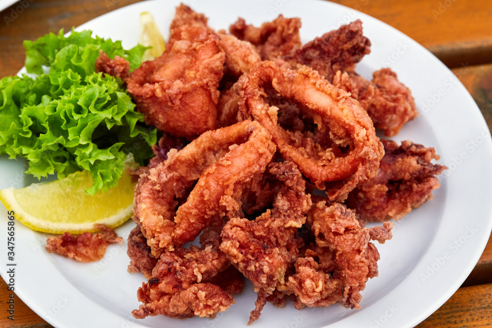 A plate full of fried squid in batter A plate full of fried squid in batter