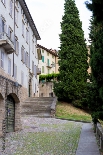 Traditional narrow Italian street with staircase and no people in Bergamo historical center, Italy. Medieval buildings. There's no one on the street.