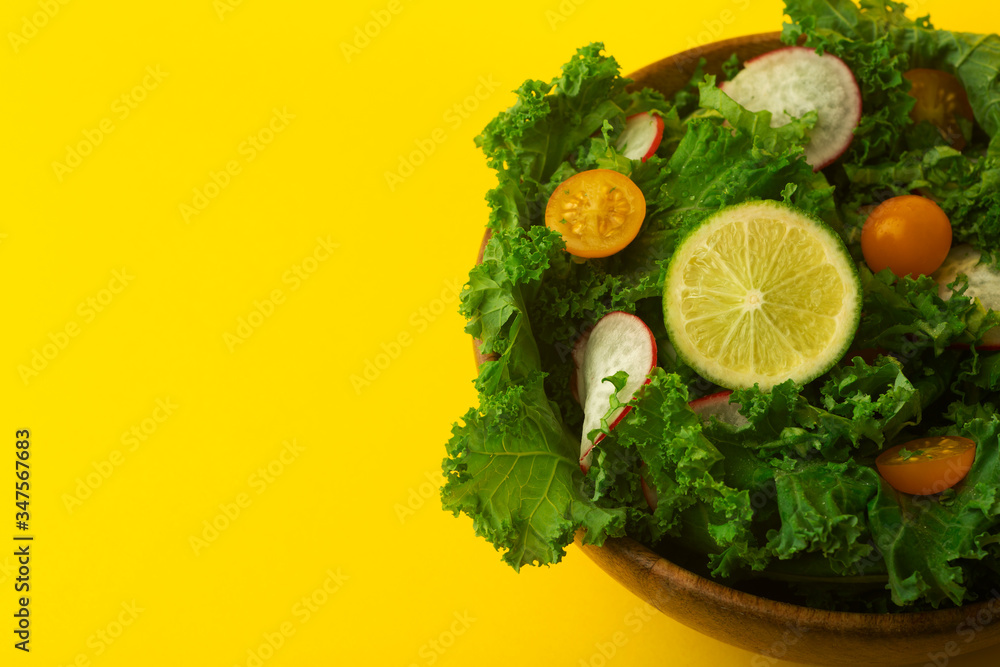 Fresh green salad in a wooden bowl. Healthy, diet, vitamins, vegetarian, proper food and lifestyle concept. Fresh green salad in a wooden bowl. Healthy, diet, vitamins, vegetarian, proper food and lifestyle concept.