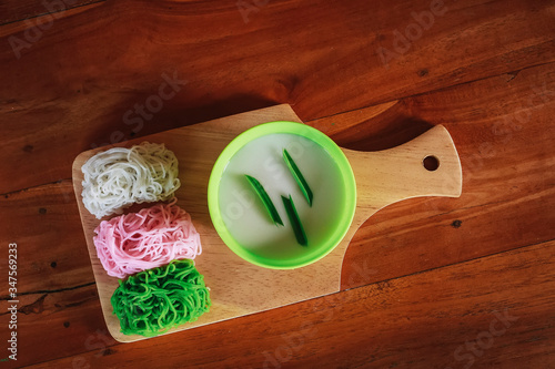 Food Photography Petulo (Putu Mayan g) is Traditional Javanese food of rice flour strands curled up into a ball; eaten with coconut milk and palm sugar. photo