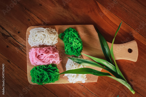 Food Photography Petulo (Putu Mayan g) is Traditional Javanese food of rice flour strands curled up into a ball; eaten with coconut milk and palm sugar. photo