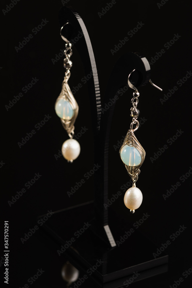 Handmade jewelry made of natural stones, isolated on black background Handmade jewelry made of natural stones, isolated on black background