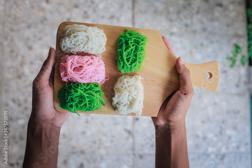 Food Photography Petulo (Putu Mayan g) is Traditional Javanese food of rice flour strands curled up into a ball; eaten with coconut milk and palm sugar. photo