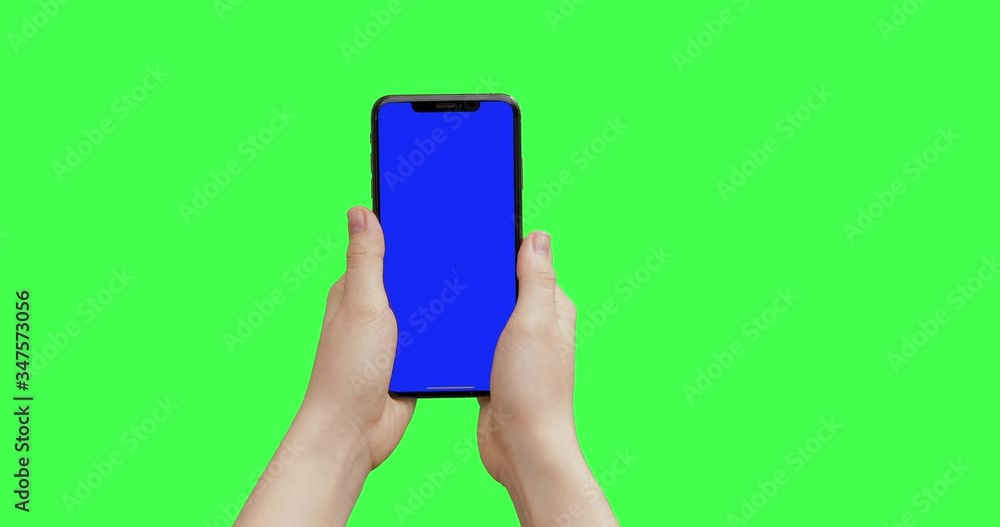 Girl hands holding the smartphone on green screen chroma key background. Mock-up for your product. The newest iPhone 11 Pro Max model in vertical orientation portrait mode. Girl hands holding the smartphone on green screen chroma key background. Mock-up for your product. The newest iPhone 11 Pro Max model in vertical orientation portrait mode.