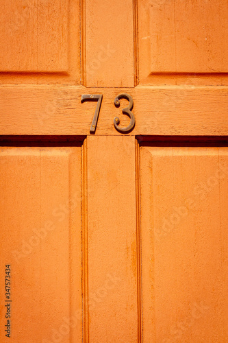 A London front door with the house number 73 photo