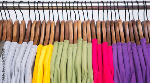 Few colored t-shirts on hangers