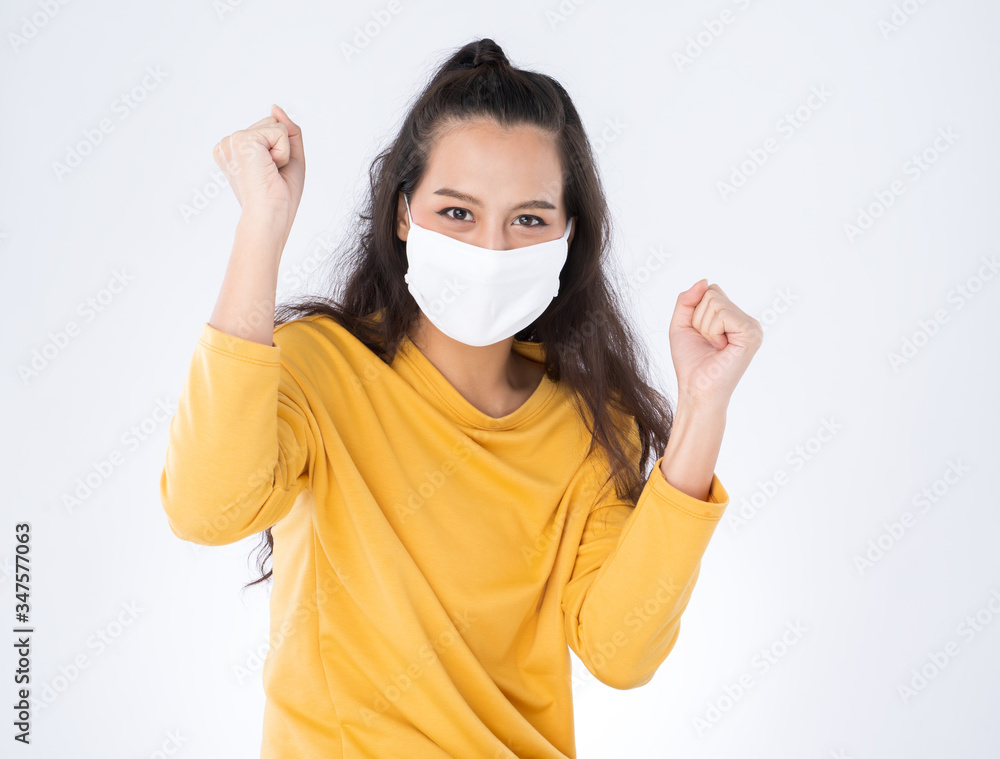 Young happy Asian woman wearing hygienic mask to prevent infection corona virus Air pollution pm2.5 she wearing a yellow sweater shoot in shot isolated on white background Young happy Asian woman wearing hygienic mask to prevent infection corona virus Air pollution pm2.5 she wearing a yellow sweater shoot in shot isolated on white background