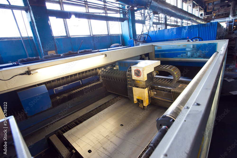 Production laser metal cutting machine cuts Sheets Of Iron Into Various Parts. CNC tool