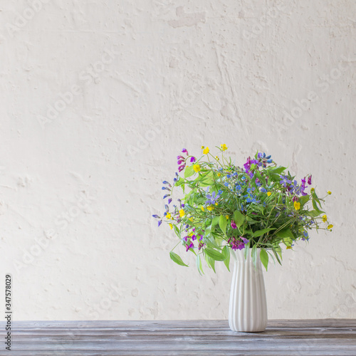 summer wild flowers in vase on white background