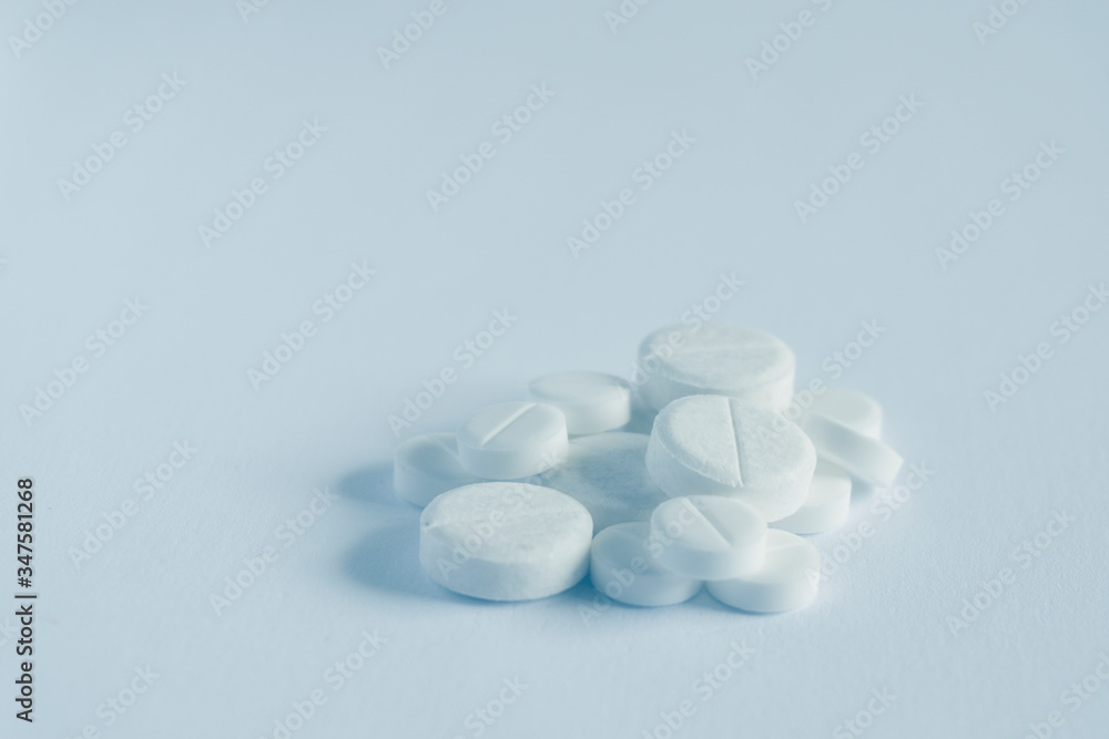 pile of pills on blue background with copy space. medicine concept pile of pills on blue background with copy space. medicine concept