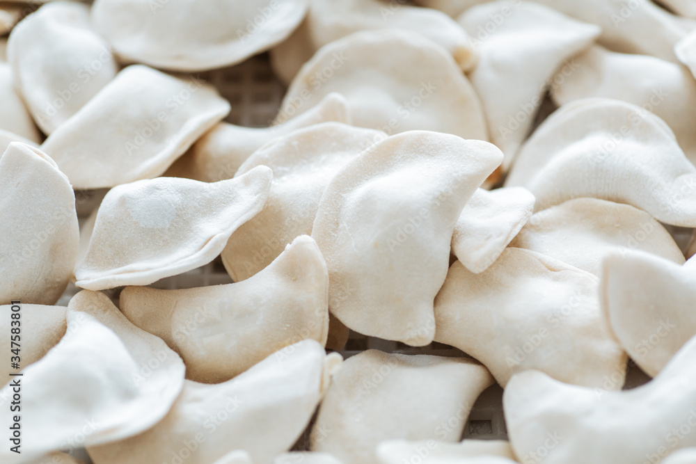 Raw dumplings from the dough in handmade flour.Close up Raw dumplings from the dough in handmade flour.Close up