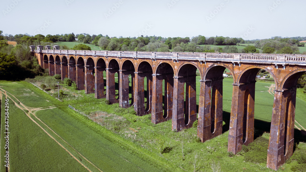 Landscape of old rustic train bridge in the  British countryside